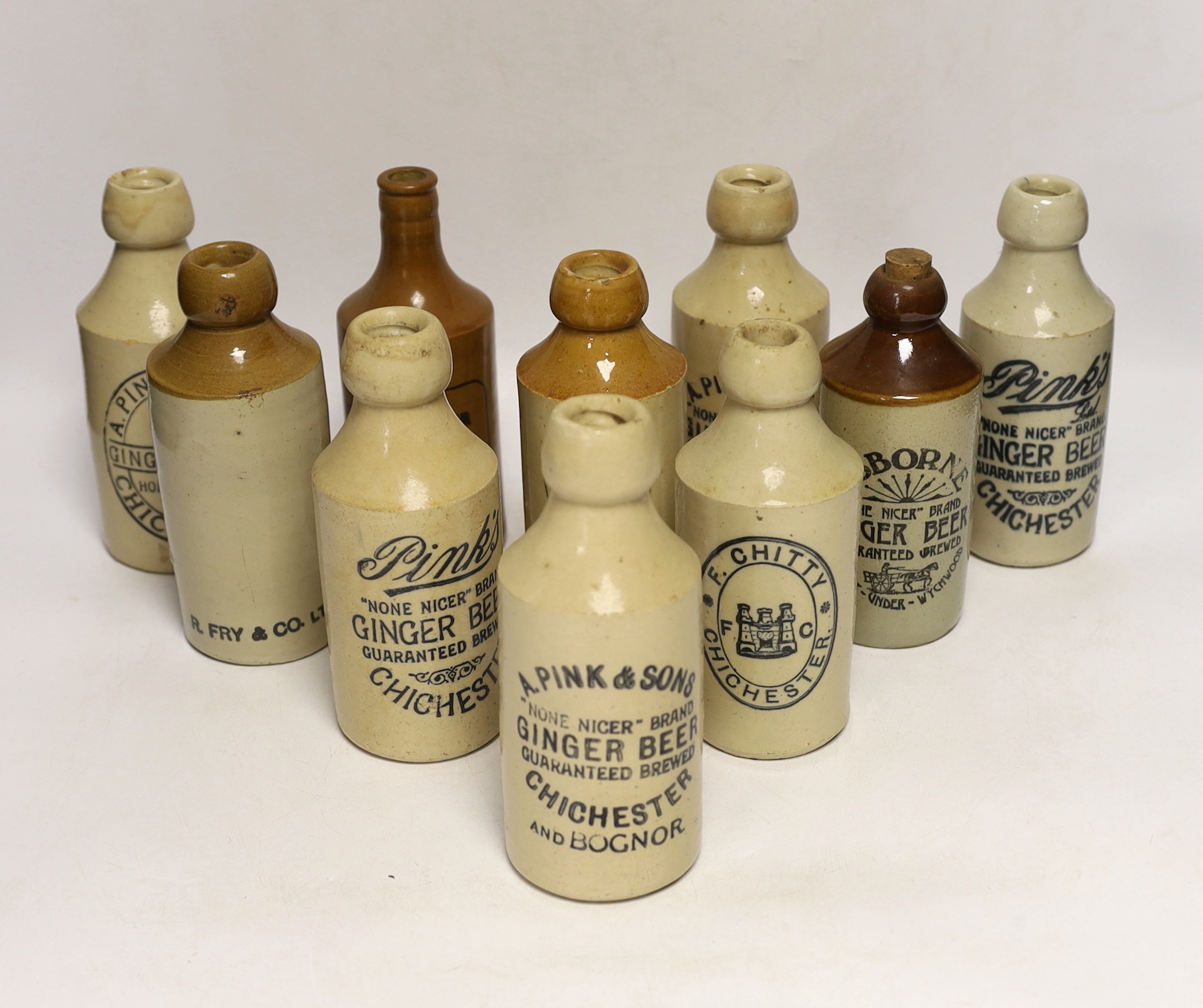 Early 20th century stoneware ginger beer bottles, six from Chichester and four others